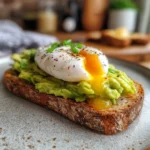 Avocado toast with poached egg on rustic bread